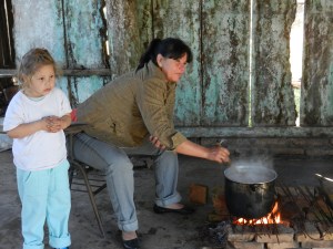 A señora making hot chocolate for the kids during El Dia de Los Niños (Day of the Children)