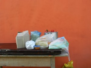 Lunch supplies: lots of spaghetti, a bucket of sweet peppers and tomatoes, bags of garlic and onions, and snacks for the cocineras (cooks).
