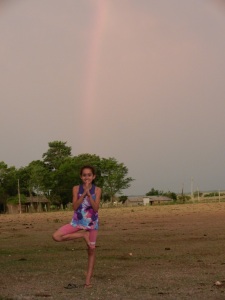 Hilda practicing her best "Tree" pose on the soccer field beneath a stellar rainbow.